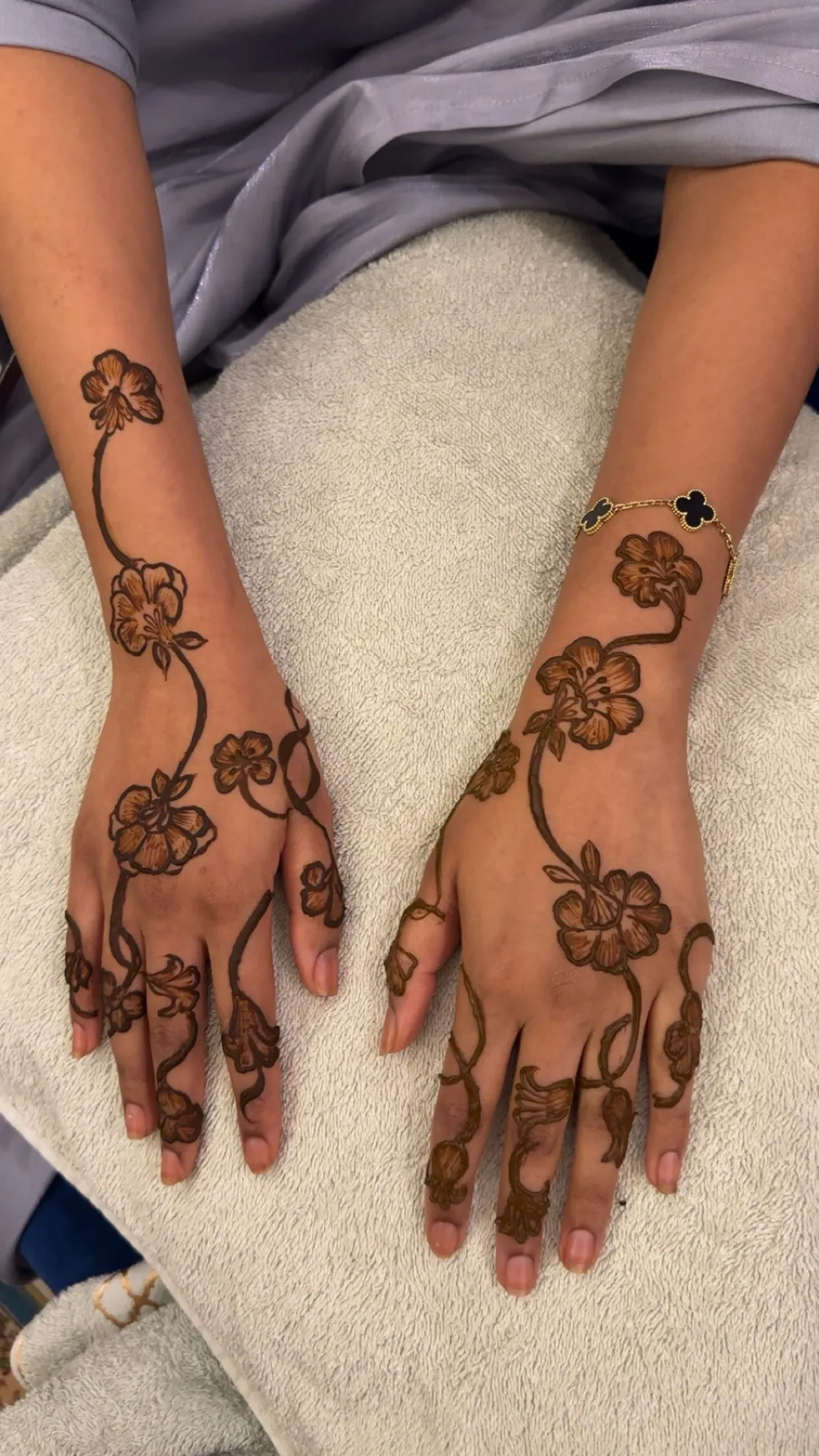 Trailing blossom henna design from wrist to fingers